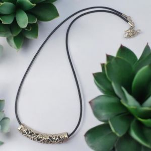 Tube pendant with black leather cord with lobster clasp and an adjustable chain at the finish