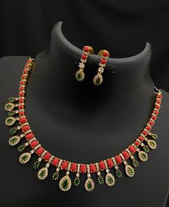 Antique finish American diamond Coral color Necklace with Green stones