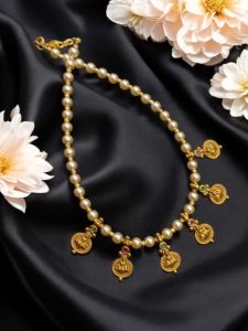 Golden pearl with antique gold coins