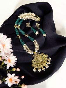 Pearl necklace with oxidised gold pendant and synthetic coral carved beads